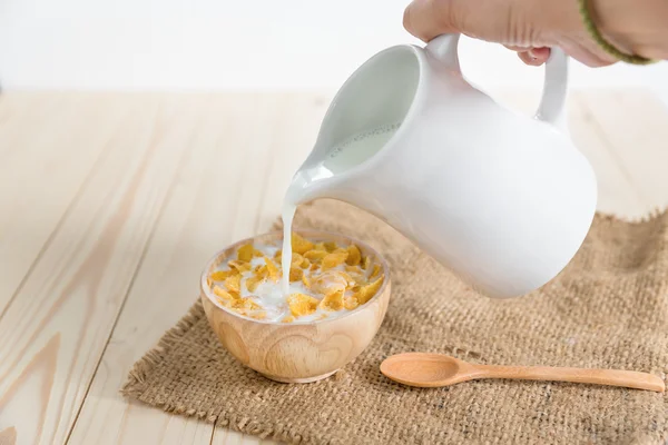 Cornflakes, milk is poured into flakes — Stock Photo, Image