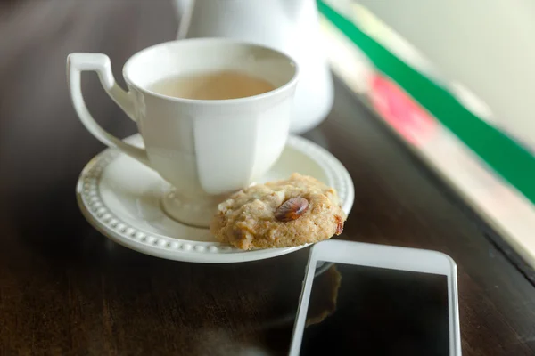 cup of tea with almond cookies