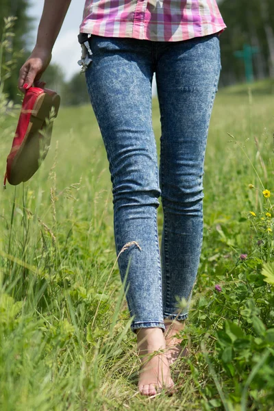 Young female legs walking on the grass in summer — Stock Photo, Image