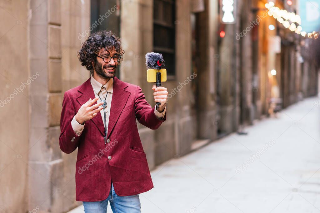 Young caucasian travel video blogger streaming from the streets of Barcelona