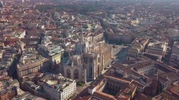 Daily life in Milan, Italy during COVID-19 pandemic. Milano, Italian city and coronavirus outbreak. Aerial view of Piazza Duomo. Historic monument and religious building seen from drone flying in sky. — Stock Video