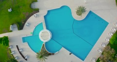 Hava görüntüsü. Yaz günü su parkı açık yüzme havuzu dinlenme alanı.