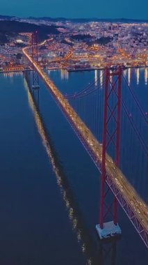  Portekiz, Lizbon 'da gün batımında Tagus Nehri üzerindeki 25 de Abril köprüsünün hava görüntüsü.