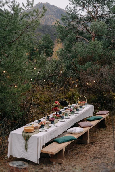 Served wedding table among trees in autumn