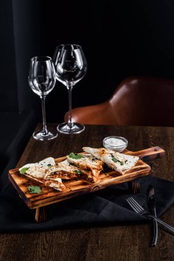 Masada aperatifler ve cam bardaklar var.