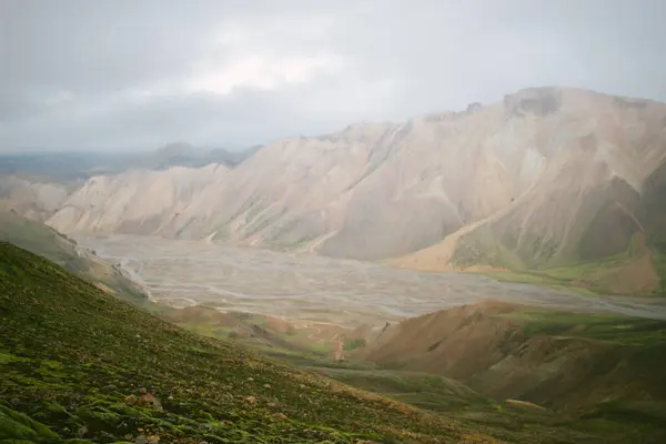 Yeşil ve kahverengi tepe karla kaplı, Gökkuşağı Dağları, İzlanda
