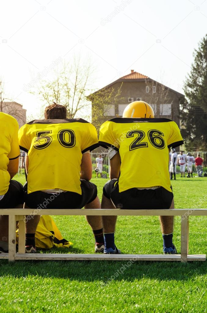 College football team sitting on the bench