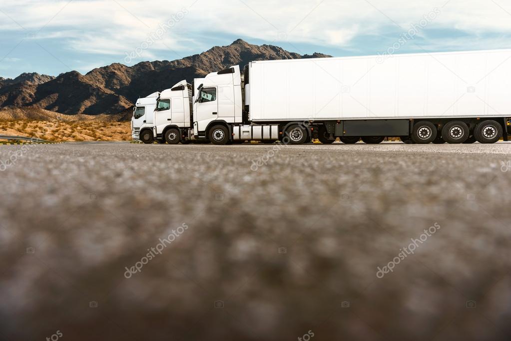 Three trucks in a row of a transporting company