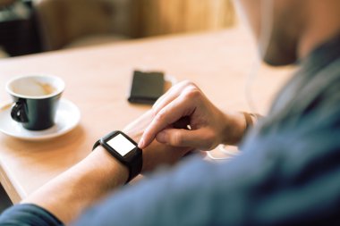 Checking his smartwatch clipart