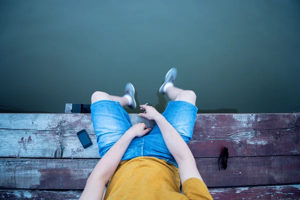 Sitting and smoking near the river — Stock Photo, Image