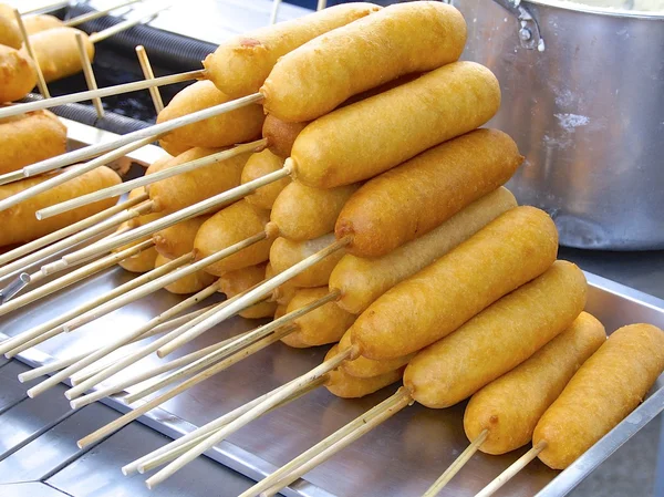 Closeup of corn dogs for sale in market — Stock Photo, Image