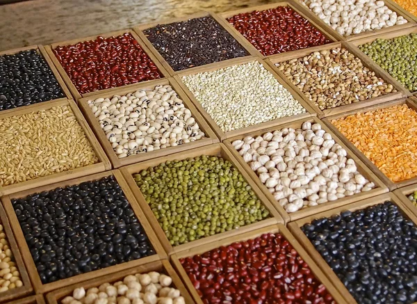 Closeup of seeds and grains in wooden box — Stock Photo, Image