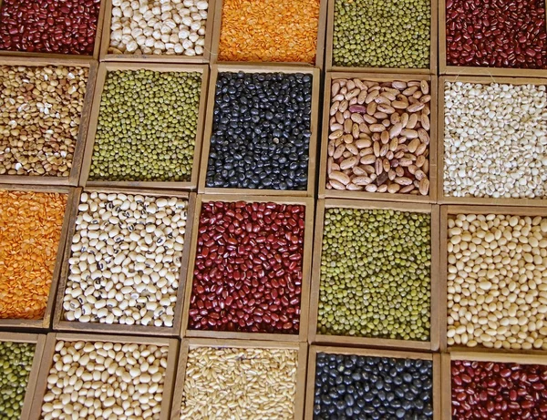 Closeup of seeds and grains in wooden box — Stock Photo, Image