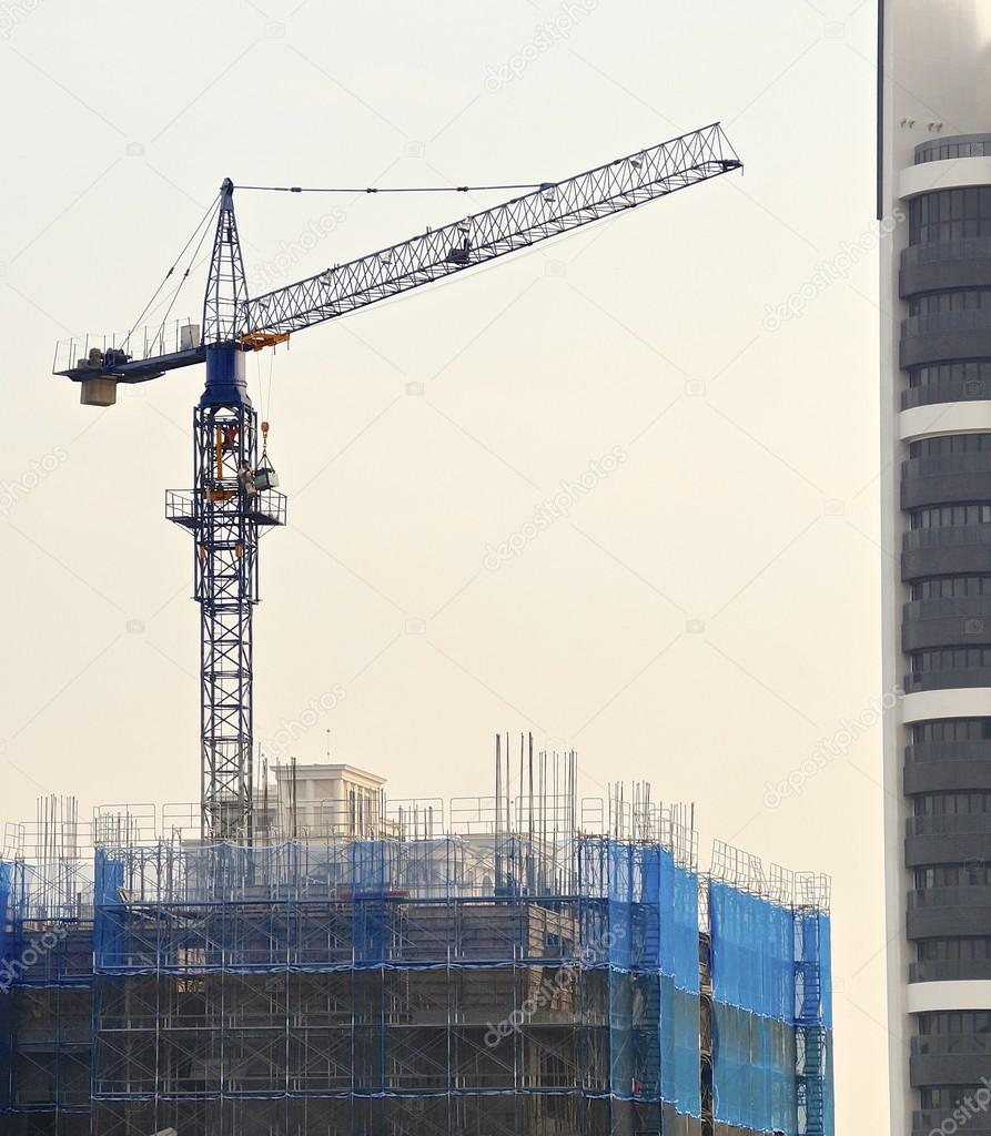 The foundation of a high rise apartment building with crane