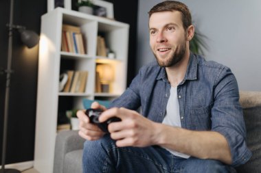 Oyun çubuğuyla video oyunu oynayan heyecanlı adam