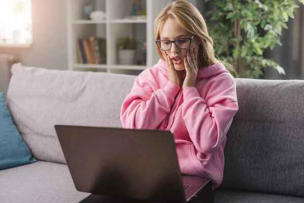 Surprised woman looking at computer