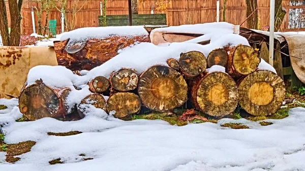Logs piled in piles are under the snow — Stock Image Logs Piled Piles Snow Stock Photo