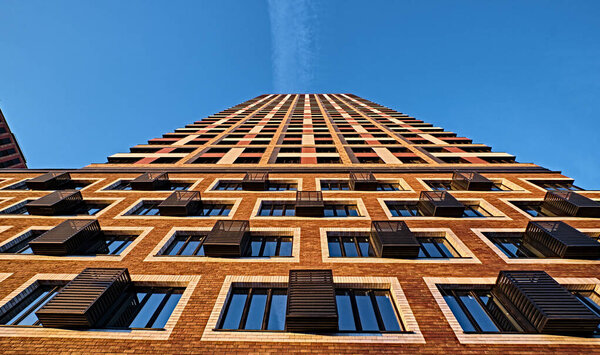 Detail of the facade of a residential building in the future against the blue sky