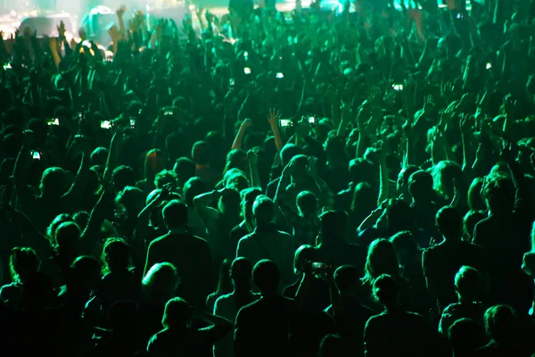 People crowd in concert lights