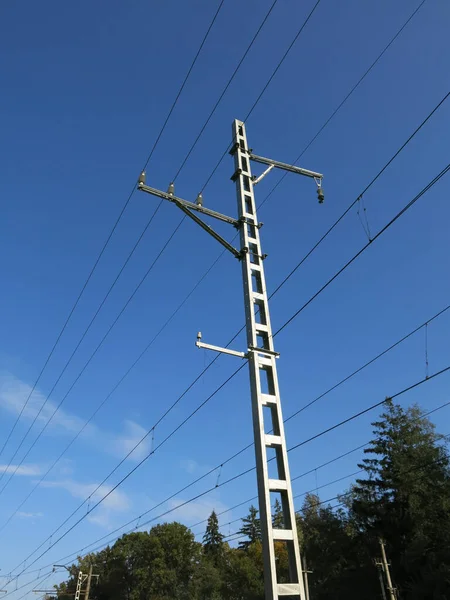 railway support tower along the village railway in Russia in summer against the blue sky