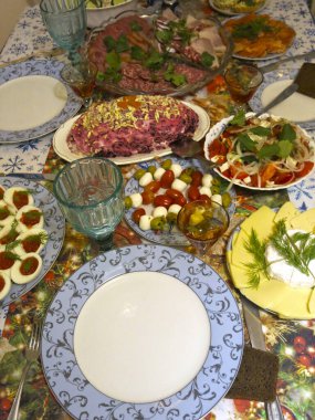 Rus şenlik masası boş mavi tabak, bardak ve lezzetlerle dolu.