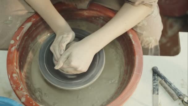 Hands of young potter, was produced on range of pot. RAW video record. — Stock Video