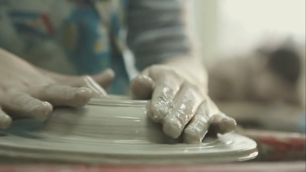 Womans hands making ceramic bowl on potters wheel. RAW video record. — Stock Video