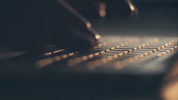 Extreme close-up of human hands on keyboard at sunset. RAW video record. — Stock Video