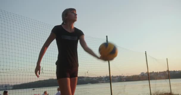 Jonge vrouw spelen strand volleybal met vrienden — Stockvideo