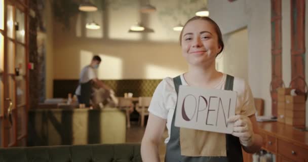 Otevření instituce poté, co karanténní dívka servírka drží talíř otevřeně odstraňuje masku usmívá se raduje chlap převrátí židle — Stock video
