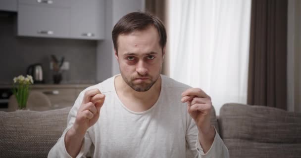 Nervous man praying on sofa — Stock Video