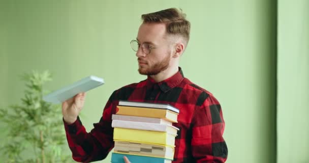 Smart man with stack of books — Stock Video