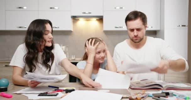 I genitori litigano con l'altro a bambino Famiglia mamma e papà figlia seduta a tavola a casa a studiare online infastidito stanco triste lancio carte litigano grido — Video Stock