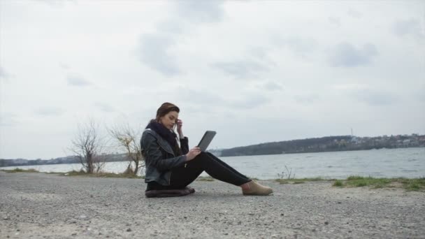 Woman use touch pad tablet pc internet technology sitting beach — Stock Video