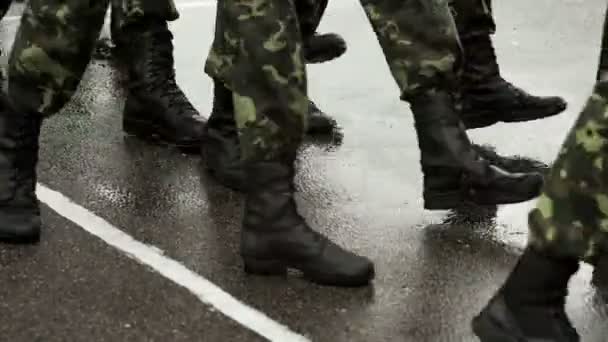 Soldaten marcheren in de regen op de parade grond — Stockvideo