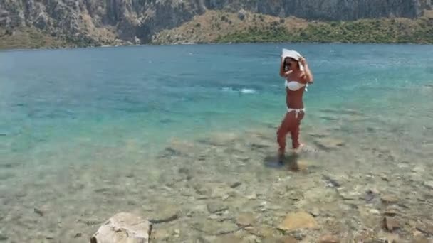 La giovane donna su una spiaggia in bikini, rocce — Video Stock