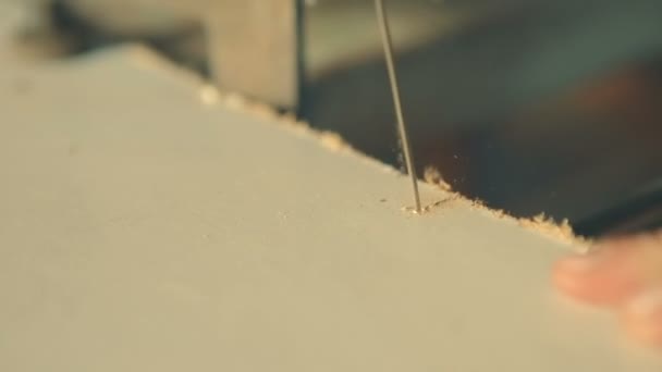 Boy with jigsaw cutting a plywood. Close-up shot of hands and jigsaw. — Stock Video