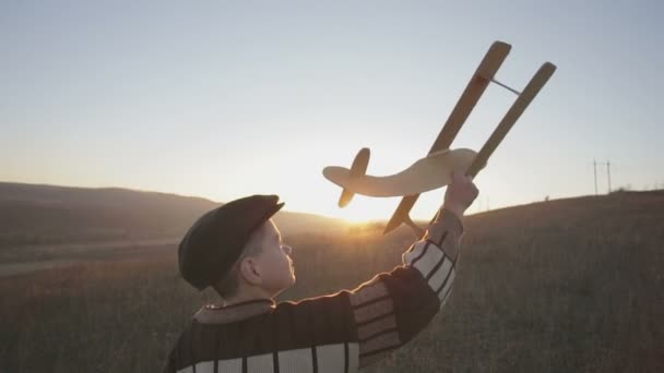 Little boy with wooden plane — Stock Video