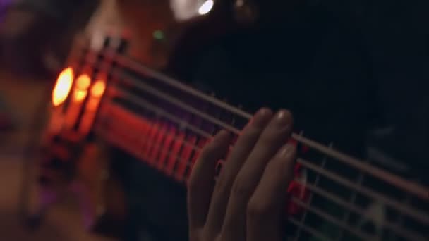 Close up of hands playing an bass — Stock Video