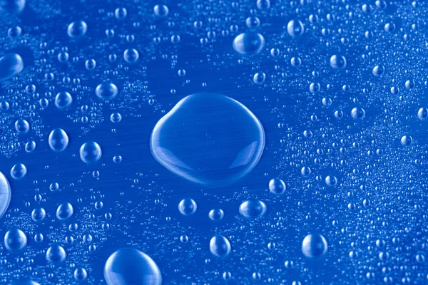 Drops of water on blue background — Stock Photo, Image