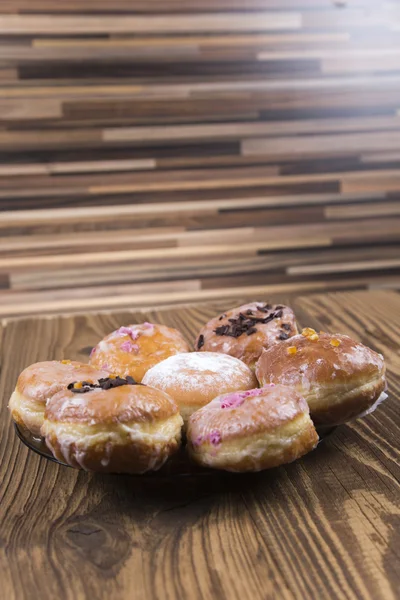 Fresh jummy donuts on wooden table — Stock Photo, Image