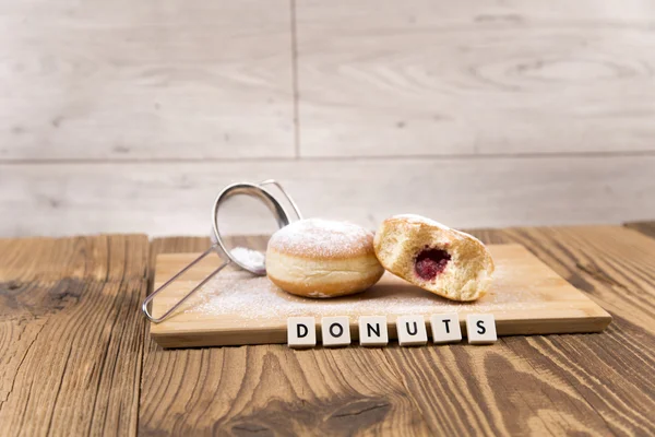 Fresh jummy donuts on wooden table — Stock Photo, Image