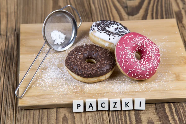 Fresh jummy donuts on wooden table — Stock Photo, Image