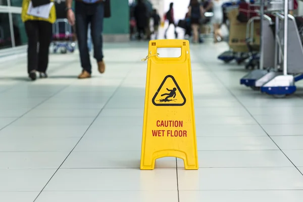 Yellow sign that alerts for wet floor. — Stock Photo, Image