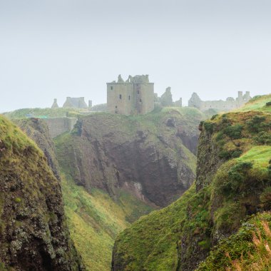 Dunnottar castle shrouded in myst clipart