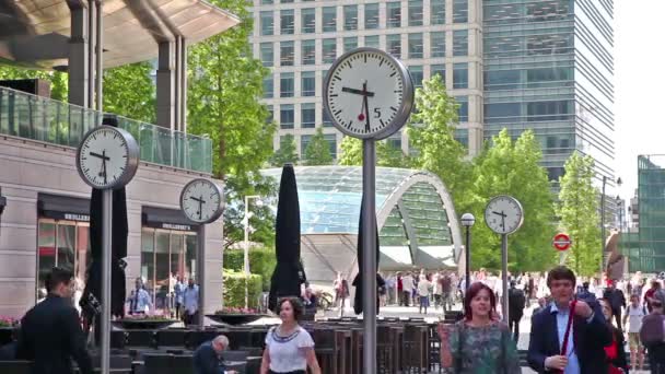 LONDRES, Reino Unido - 03 de julio de 2015: Viajeros que se apresuran a trabajar en Canary Wharf. Mucha gente pasando por la famosa plaza con relojes — Vídeo de stock