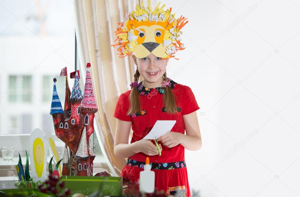 Little girl demonstrating her art craft works, Paper masher fairy castle. Little girl demonstrating her art craft works, Paper masher fairy castle and Lion paper mask.