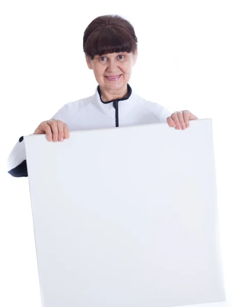 Mature woman leaning on white banner. Portrait against of white background — Stock Photo, Image
