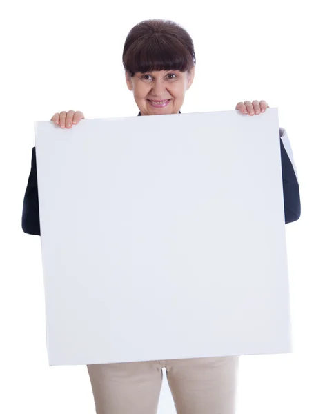 Mature woman leaning on white banner. Portrait against of white background — Stock Photo, Image