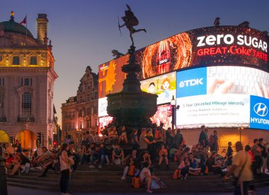 LONDON, UK - AUGUST 22, 2014: Piccadilly Circus in night. Famous place for romantic dates. Square was built in 1819 to join of Regent Street clipart